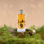 Ameer Al Oudh Intense Oud bottle on a mossy rock with ferns